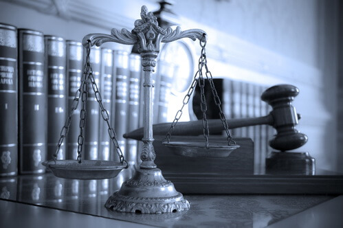 Symbol of law and justice on the table, law and justice concept, focus on the scales, blue tone