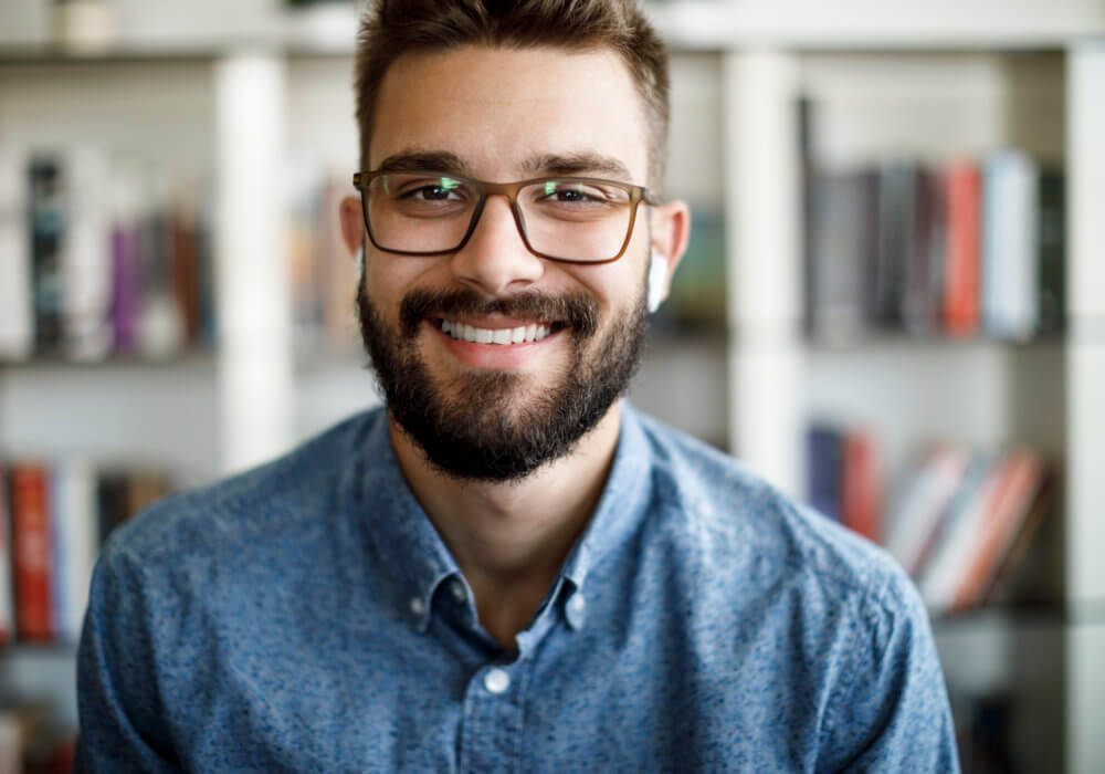 A bearded man with glasses conducts Zoom interview using best Zoom Interview tips